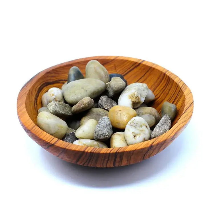 bowl carved by skilled artisans with stones in it