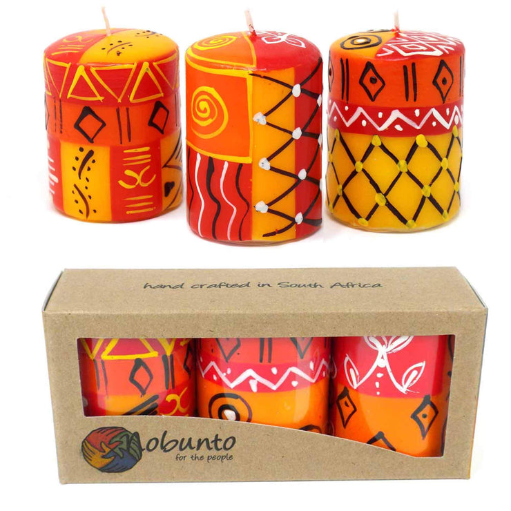 Close-up of bright hand-painted candles with geometric patterns