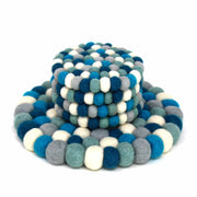 "Close-up of artisan felt coasters in soft cool tones handmade"