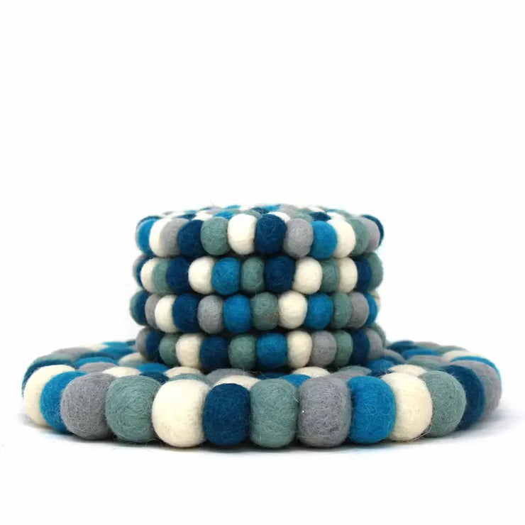 Stack of blue, gray, and white circular felt toys on a white background