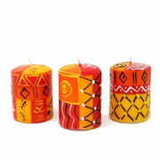 Boxed set of three artisan hand-painted candles with colorful designs