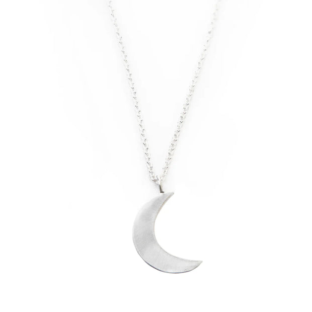 Silver-polished moon pendant close-up - ethical handmade jewelry