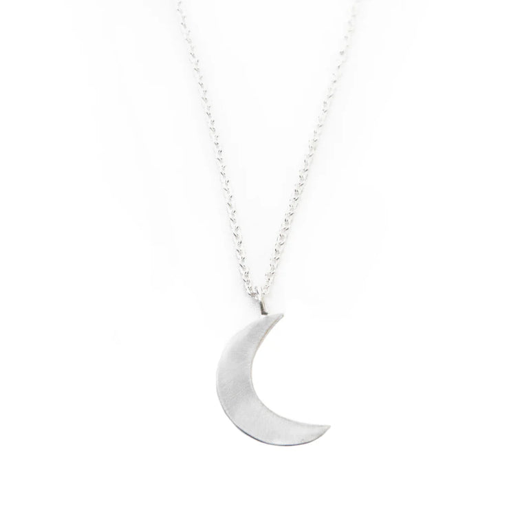 Silver-polished moon pendant close-up - ethical handmade jewelry