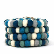 Stack of multicolored felt ball bracelets on a white background