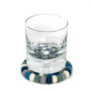 "Arctic blue handcrafted wool coasters on wooden table" 