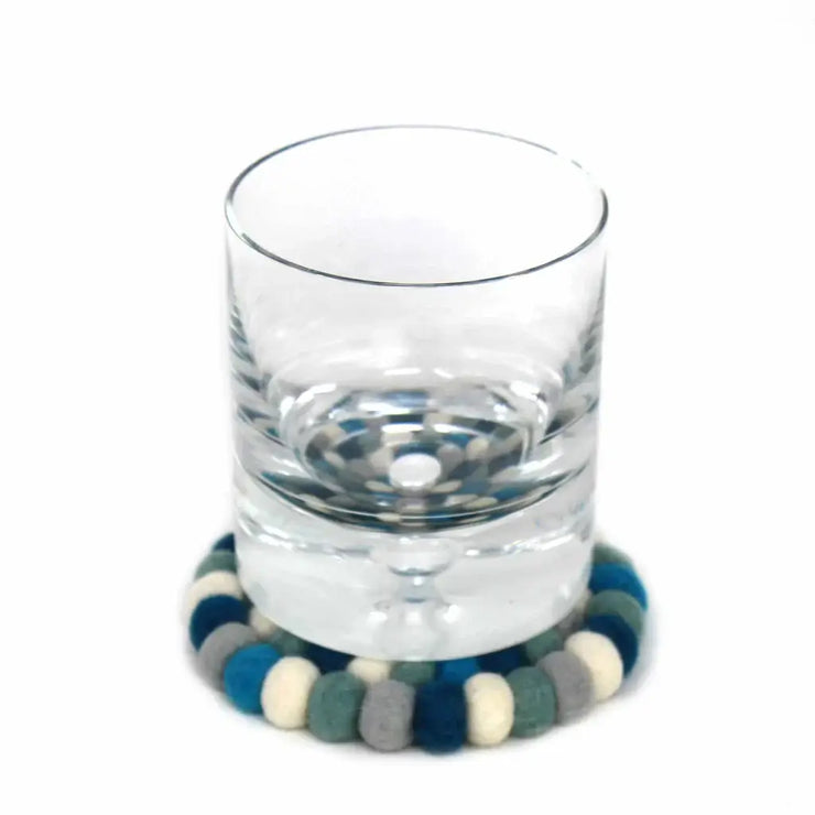 "Arctic blue handcrafted wool coasters on wooden table" 