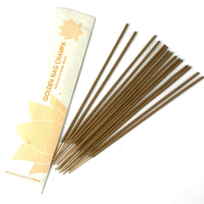 Golden Nag Champa stick incense burning with soft smoke trail