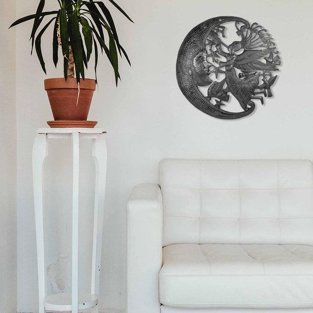 Detailed hand-cut and embossed angel and moon metal art, crafted in Haiti
