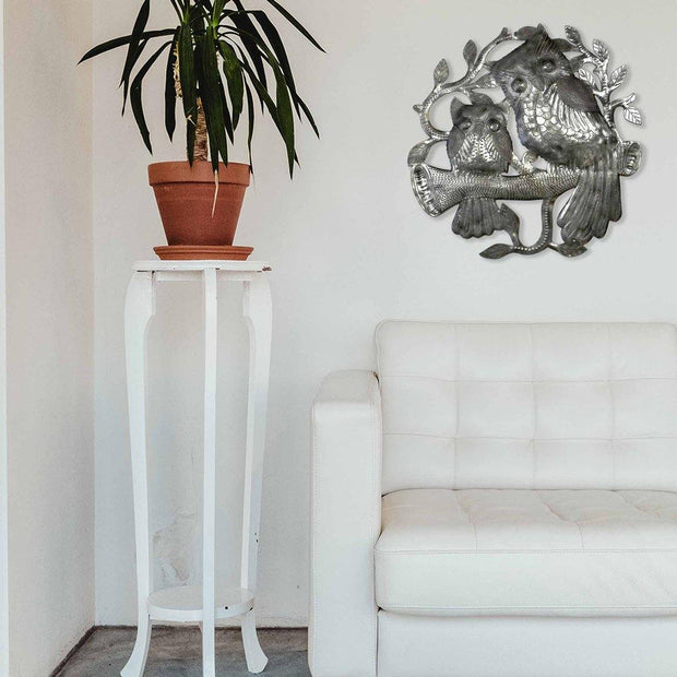 side angle of fair trade recycled steel owl wall art, hanging outdoors