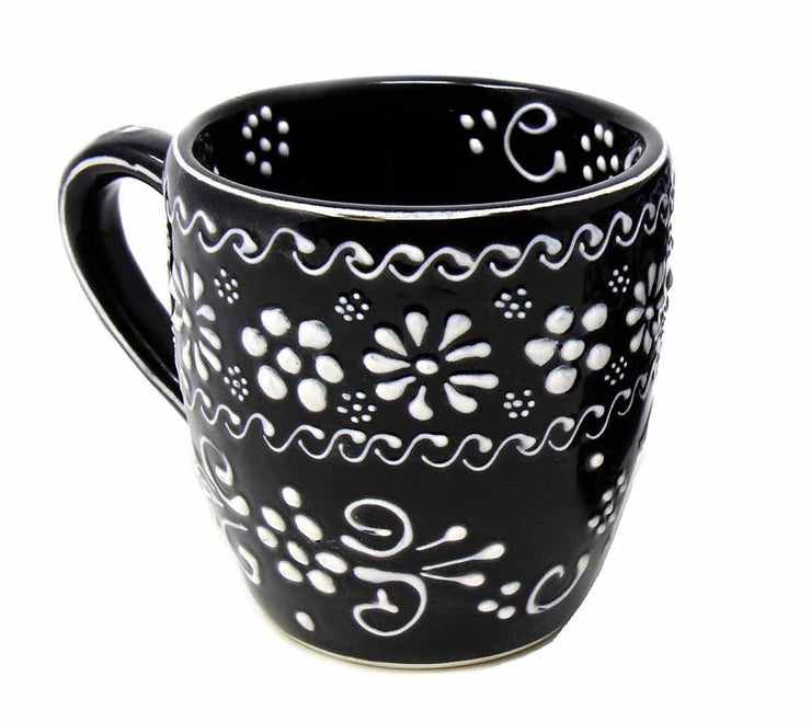 Side view of artisan Mexican pottery cups showing hand-painted texture